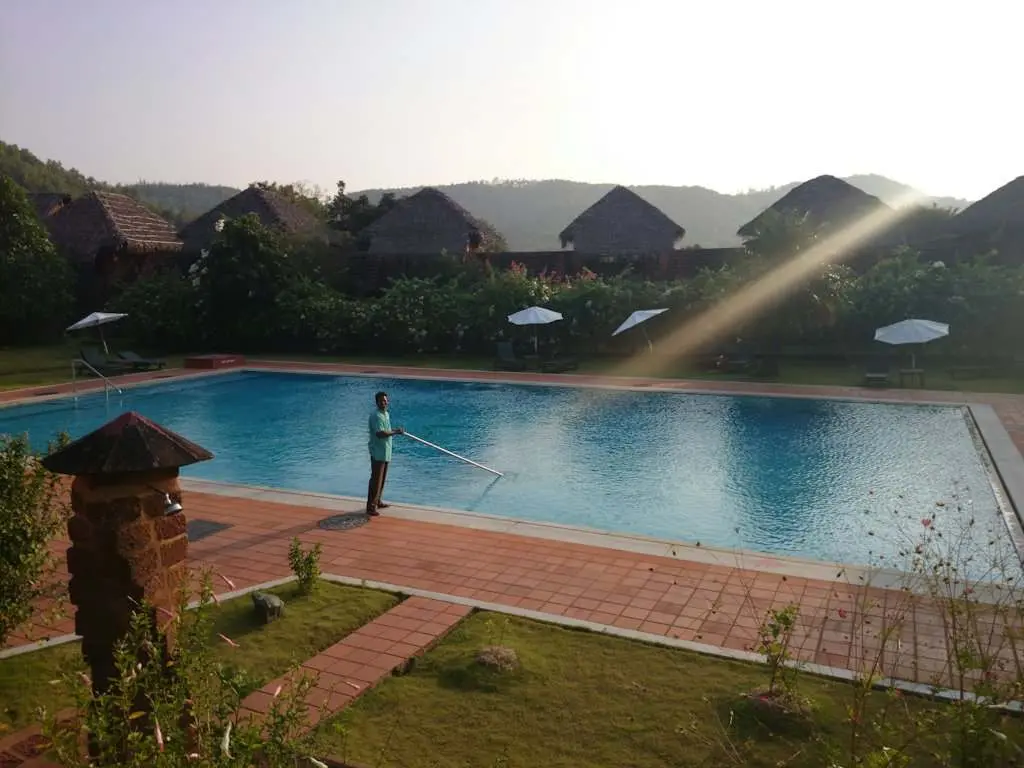 A technician servicing a resort pool